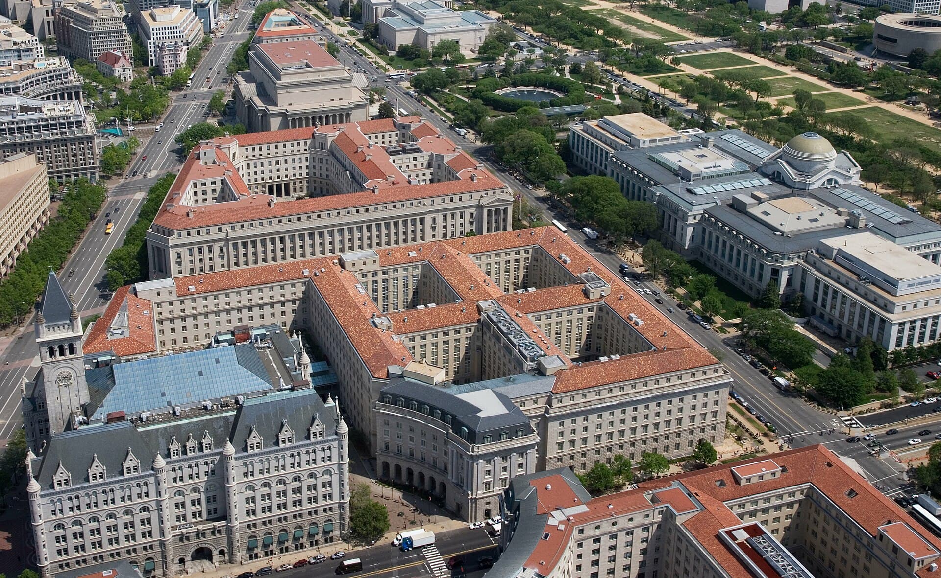 Aerial view of Pennsylvania Avenue (left) and the Federal Triangle (center) , facing east towards the United States Capitol in Washington, D.C. Visible landmarks include the Old Po