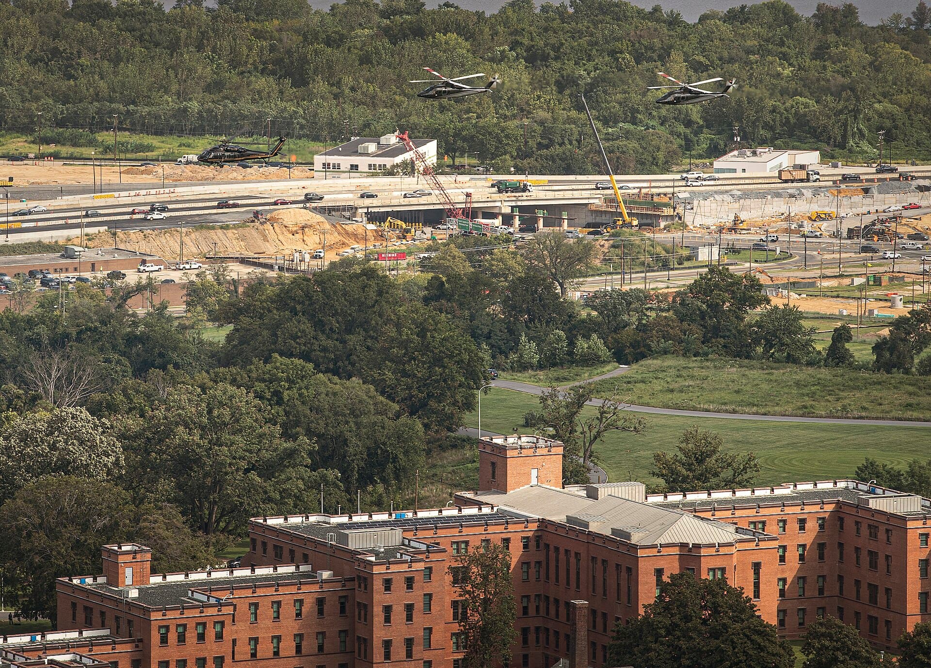 Three U.S. Customs and Border Protection Air and Marine Operations aircraft, distant top, conduct a flyover of the U.S. Department of Homeland Security Headquarters, St. Elizabeths